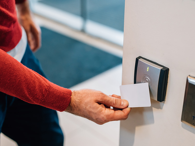 Swiping an access card at a door