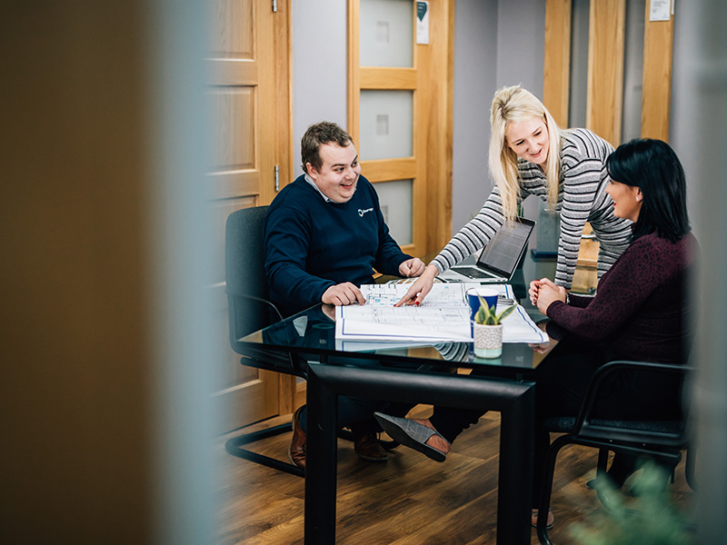 Colleagues discussing plans in a meeting