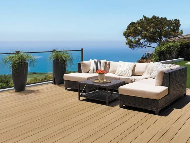 Modern outdoor patio overlooking the ocean featuring Composite Prime decking and modern rattan furniture
