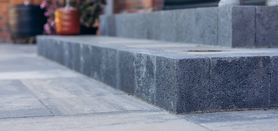 Close-up of dark grey Tobermore step risers creating a safe, stylish transition between garden levels.